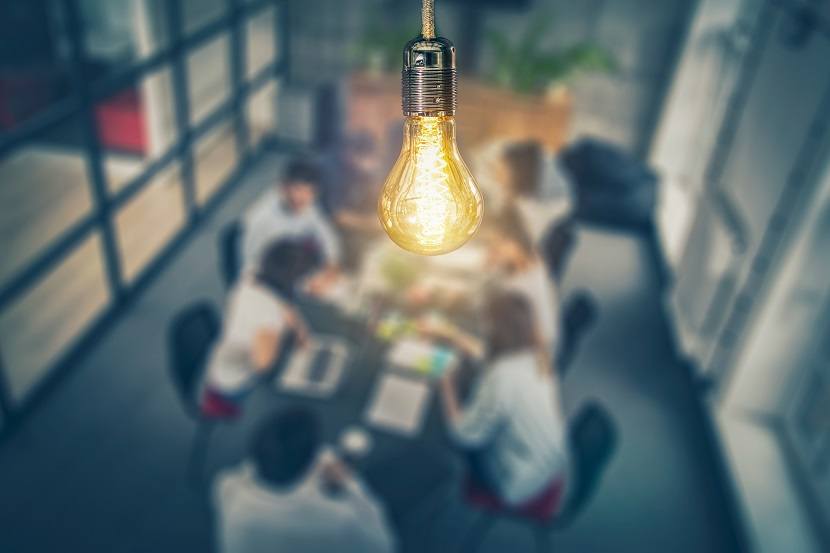 Light Bulb Above People Working at a Table